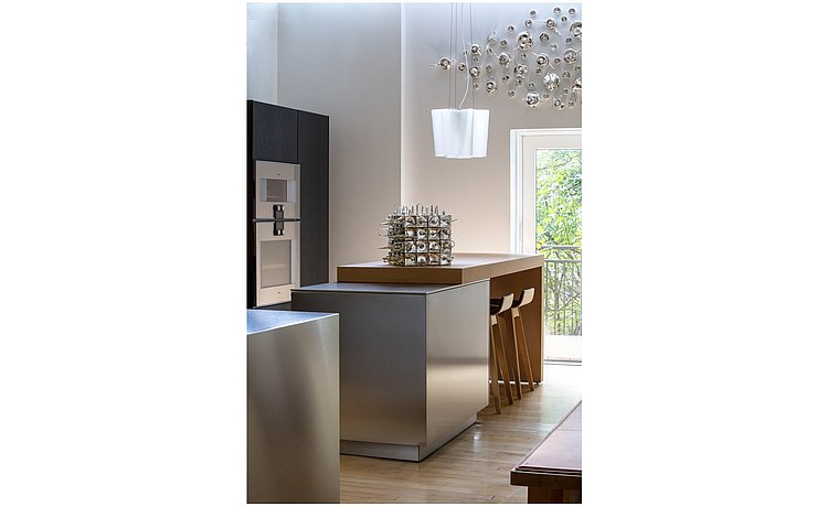 kitchen island with artwork and pendant lamp