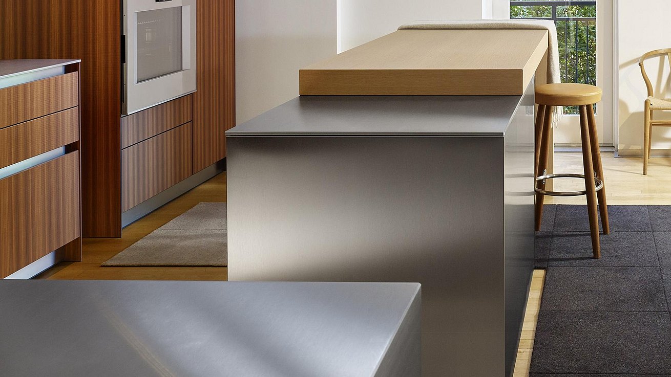 Details of b3 kitchen featuring bar top in oak and lush finish of stainless steel surfaces. 